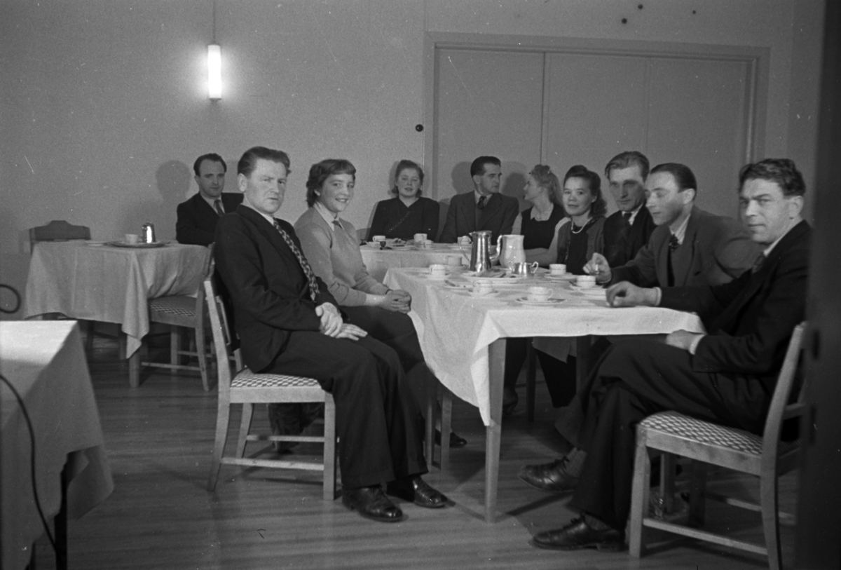 Håkon Prestkværn, Menn og kvinner drikker kaffe rundt et bord.