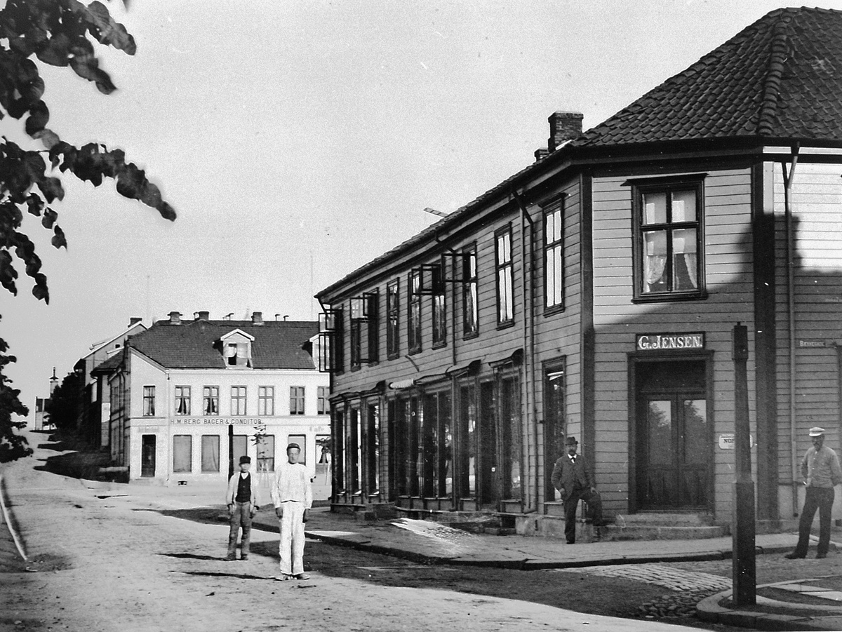 Hans Emil Erichsen, Simensgården. G. Jensen Kolonialforretning i Strandgata, Hamar. Satt opp i 1850, gården brant ned i 1946. I dag ligger "Casa Blanca" her.